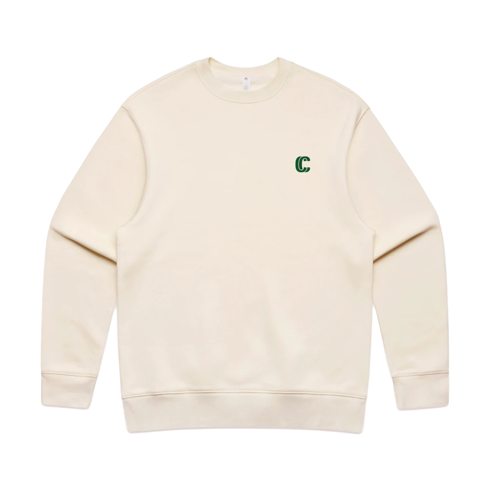 An off-white crewneck sweatshirt with a small green embroidered letter 'C' on the left chest, displayed flat against a solid white background.
